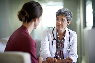 Doctor talking to woman