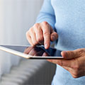 Man pressing the screen of a digital tablet