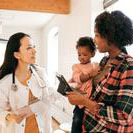 mom holding baby, talking to doctor