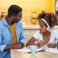 Father and daughter arguing over homework. Daughter looks pouty and disgruntled.