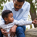 Father sitting and talking to his toddler